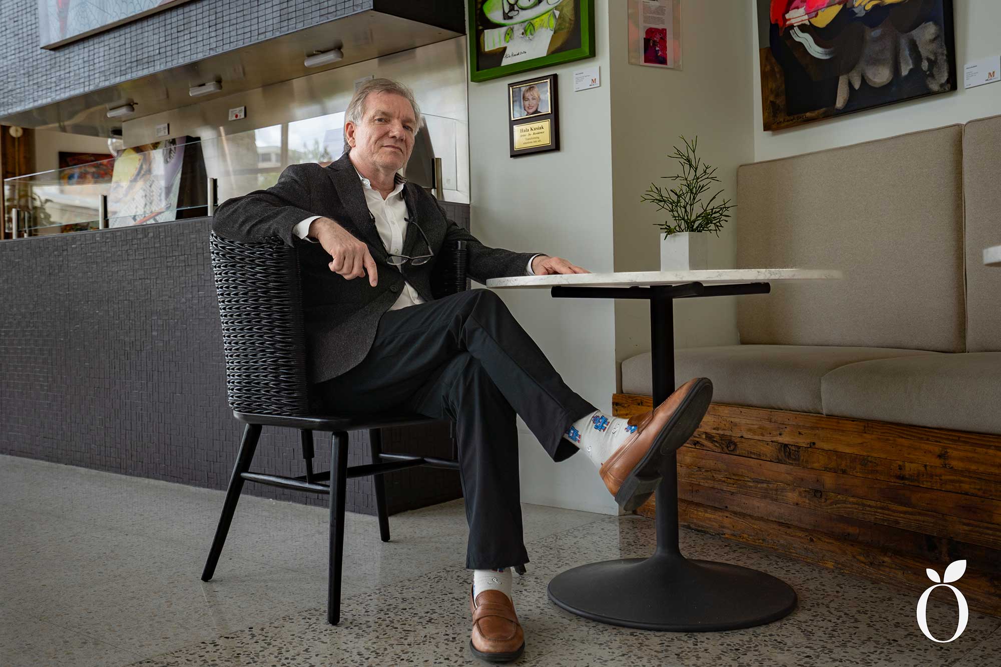 Boris Garb, sits at a bistro table at Mills Gallery in Winter Park